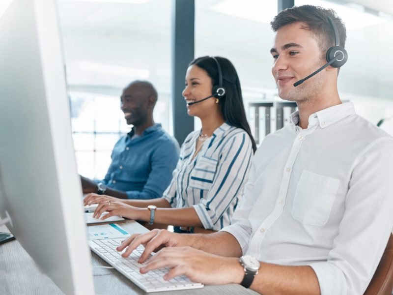 Call center, agent and telemarketing company, team and teamwork in an office or workplace working t.